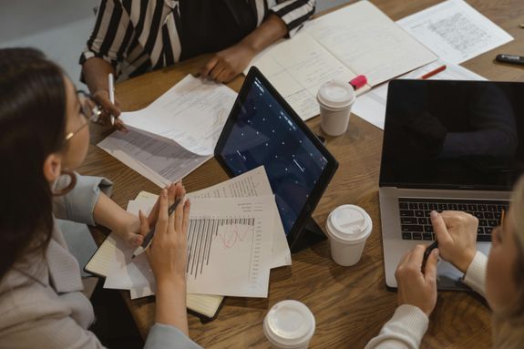 Files and portable gadgets on a tabletop during bookkeeping work